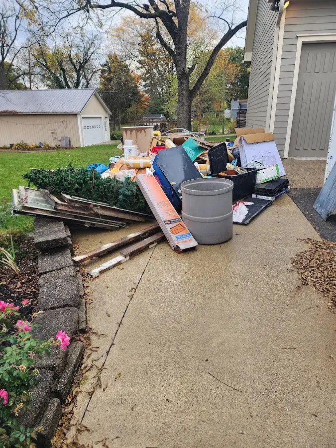 Dumpster being loaded with debris for Commercial Dumpster Rental in Gulf Park Estates